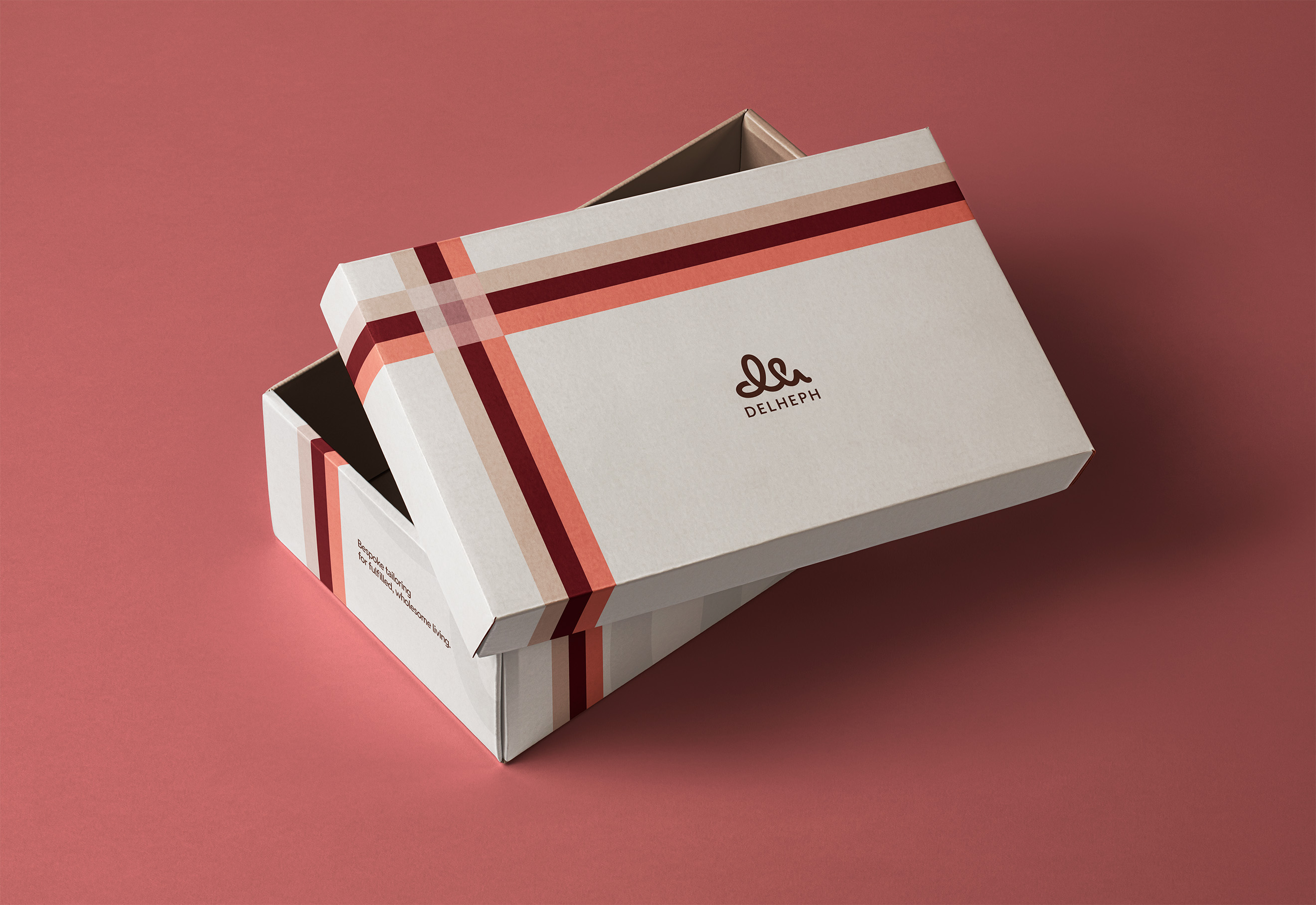 Del Heph packaging box cover with burgundy and blush signature stripes